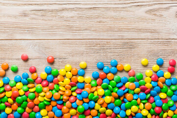Mixed collection of colorful candy, on colored background. Flat lay, top view. frame of colorful chocolate coated candy