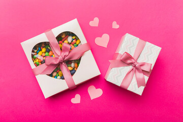 Valentine day composition: sweet candy, with gift boxes with bow and red felt hearts, photo template, background. Top View with copy space