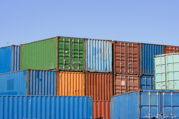 Flatly exposed cargo containers against the blue sky