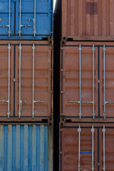 Closed doors of multicolored cargo containers in the port