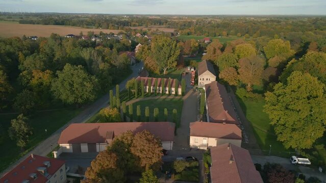 castle with forecourt with trees at summer evening. Marvelous aerial view flight wide orbit overview drone
Paretz brandenburg havelland Germany 2022. High Quality 4k Cinematic footage