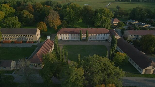 golden hour long shadow Paretz castle brandenburg. Unbelievable aerial view flight panorama overview drone havelland Germany at summer evening 2022. High Quality 4k Cinematic footage