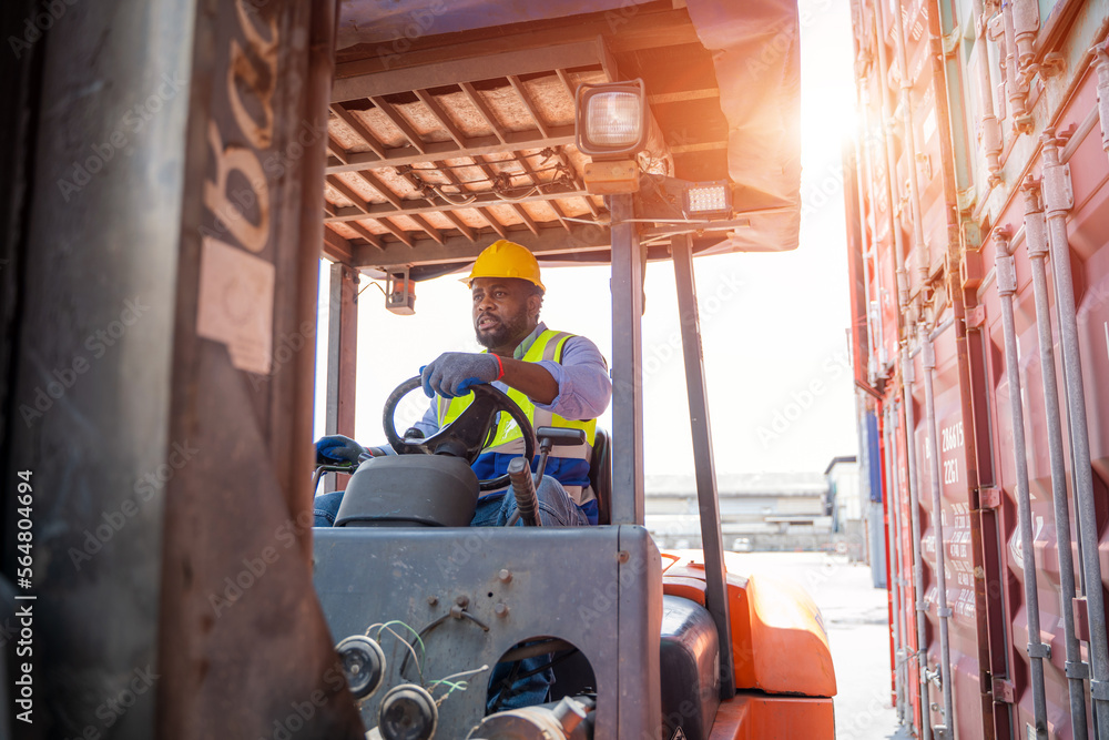 Poster technician operates a forklift tractor to move containers around the shipyard,logistics and transpor