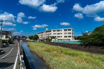 Fototapeta na wymiar The building of Old style public elementary school is built by a canal in Fukuoka city, JAPAN.