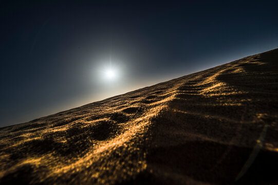Silhouette of sunset in the sahara desert.