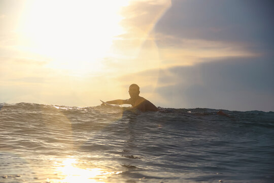 Surfer at sunset time