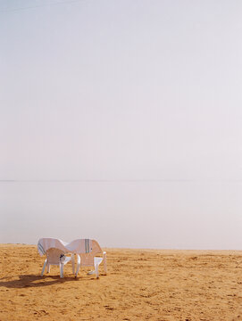Two chairs on shore of Dead Sea, Israel
