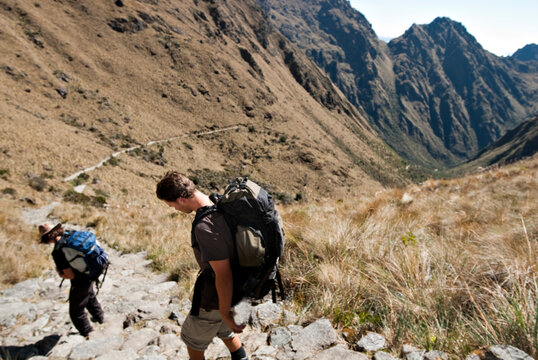 Two young men begin the decent from Dead Woman's Pass to camp three on the Inca Trail.