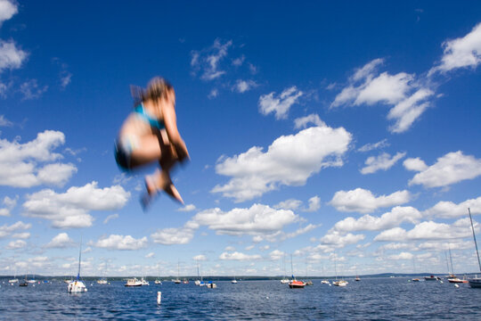 Jumping off the pier at Bayside, a community of 19th Century Victorian cottages in Northport, Maine.