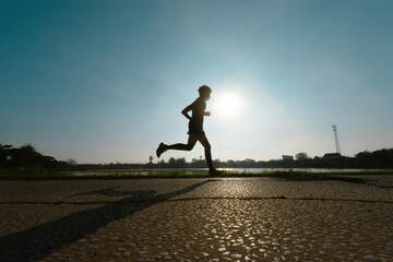 Asian man runners, he was running on the road in the morning..