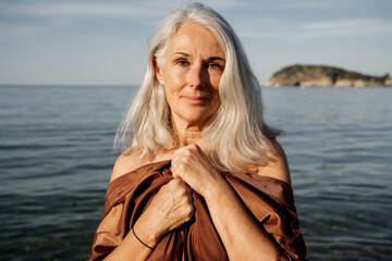 Naklejka premium Grey hair mature woman beach portrait