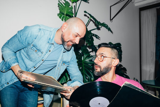 Men Holding Vinyl Records 
