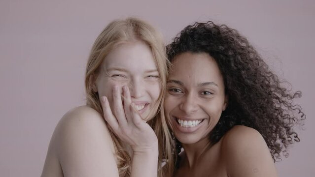Closeup portrait of two young beautiful smiling hipster female in trendy summer clothes.Sexy carefree women posing on street background. Positive models having fun and hugging. High quality 4k footage