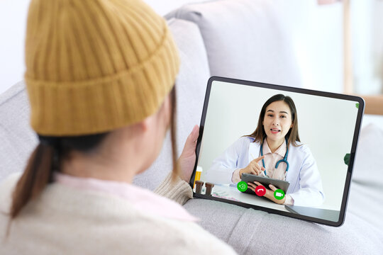 Asian woman patient make video call counselling doctor about healthcare by digital tablet, Telemedicine, Pharmacist