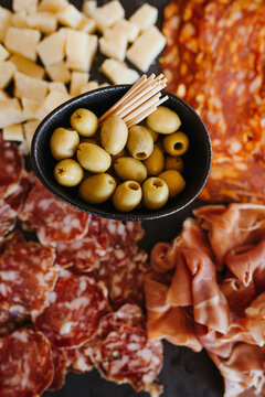 charcuterie board with salami, cheese, olives and ham