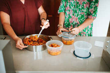 Mother and daughter prepping food in the kitchen