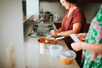 Mother and daughter prepping food in the kitchen