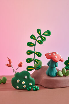 Plasticine sculptures of children make plants and mushroom