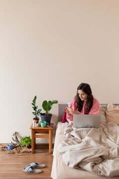 woman in bed with phone