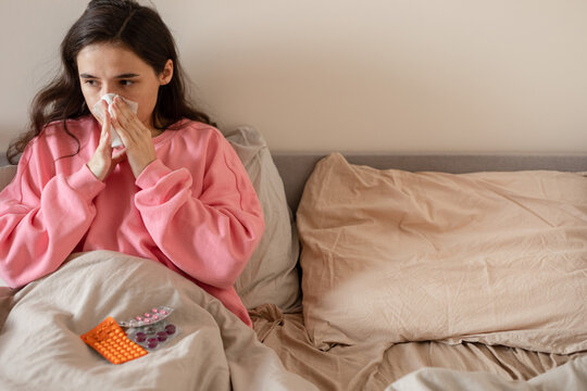 girl wiping her nose with a handkerchief