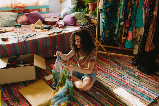 Young girl flding a colorful shirt