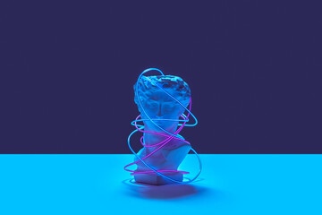 Greek statue wrapped in bright led strip.