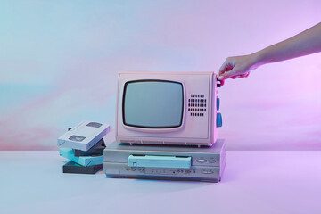 VCR player with TV turned on by woman's hand.