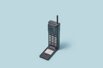 90s flip cell phone on light blue background.