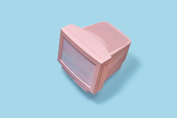 Pink computer CRT monitor on blue background.