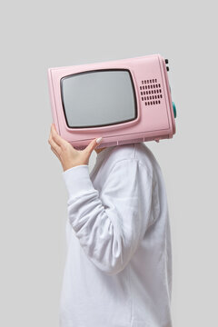 Retro pink TV in a place of woman's head.