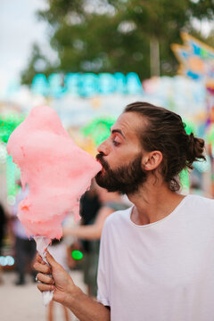 Male eating candy floss in weekend