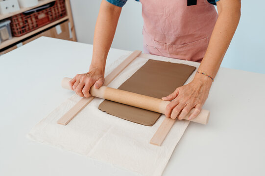 Crop potter rolling clay