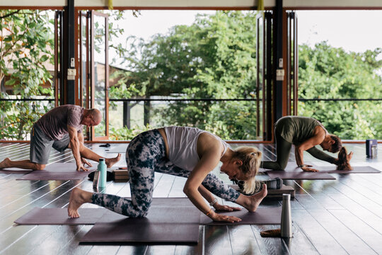 People taking a cross-mat yoga class
