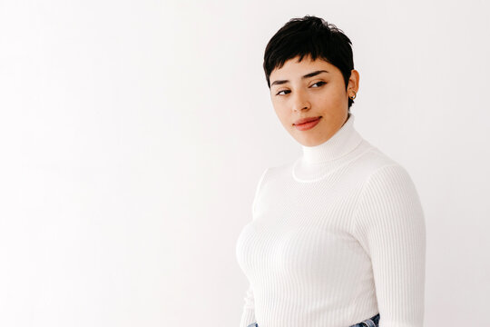 Positive Hispanic female looking away