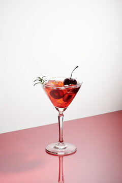 a glasses of pink gin or vodka infused with fresh cherry