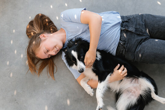 Woman caressing Border Collie on floor