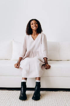 Cheerful teenager sitting on couch