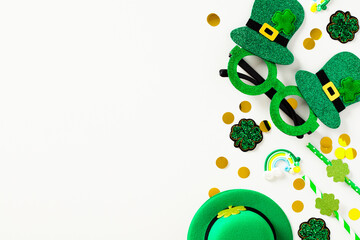 St Patrick's Day flat lay composition with green party glasses, leprechauns hat, drinking straws,...