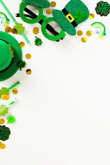 Fototapeta na wymiar St Patrick's Day party invitation template, poster, vertical banner mockup. Flat lay party glasses, leprechauns hat, drinking straws, confetti on white background,