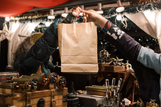 Brown shopping bag being purchased with goods on Xmas Market
