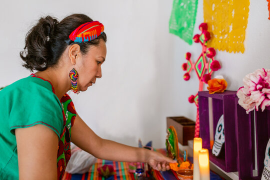 Woman preparing Day of the Dead  altar