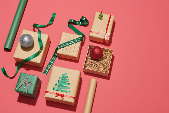 Gift boxes, paper's rools and decorations on color background