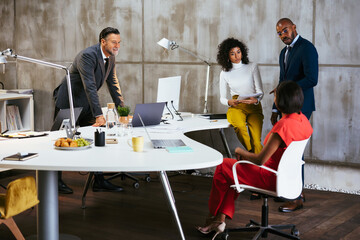 Diverse colleagues discussing documents in office