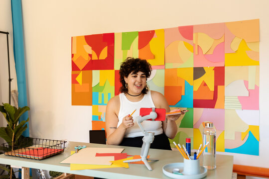 Freelance designer woman making zoom in her studio