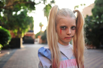 A tween girl is dressed up as a creepy doll for Halloween