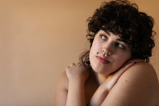 Short curly haired woman nude portrait