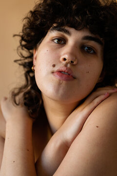 Short curly haired trans woman nude portrait
