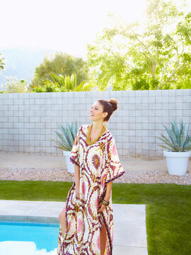 Portrait of woman by pool laughing