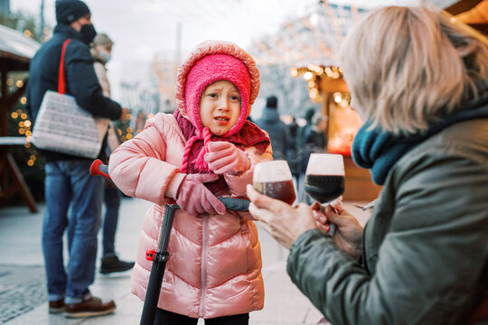 Little girl in pink being unhappy at the Christmas market 