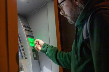 portrait of a man at an ATM